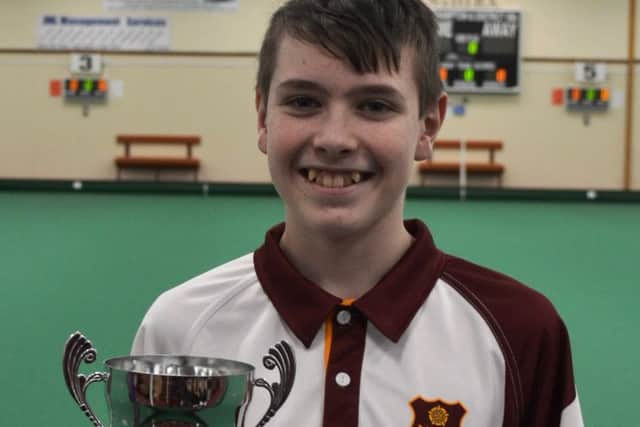 Northampton & District IBCs Thomas Manderson with his Northants Bowls Youth Development Scheme Junior Section title trophy