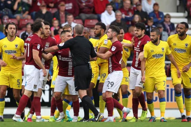 John-Joe O'Toole in the thick of the action during the Cobblers' 1-0 defeat to AFC Wimbledon at Sixfields in October
