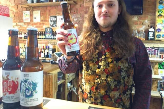 University of Northampton graduate Luke Knight with one of his designer beer bottles.