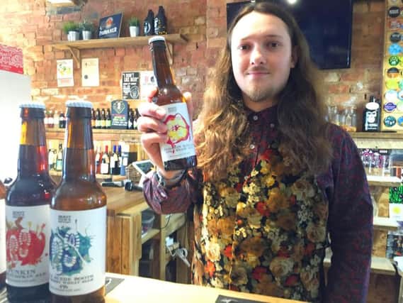 University of Northampton graduate Luke Knight with one of his designer beer bottles.