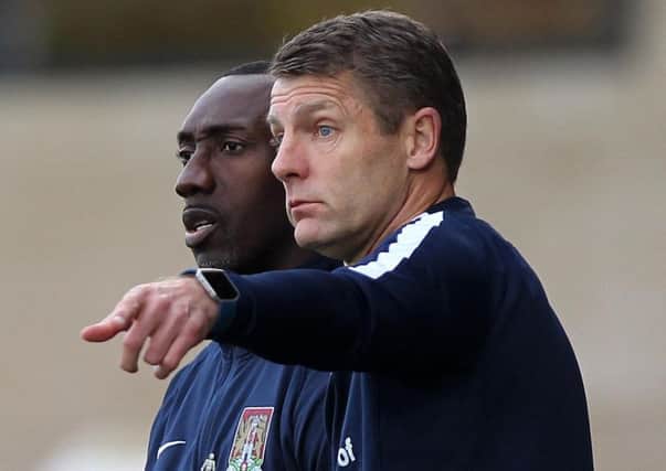 Cobblers assistant boss Dean Austin and manager Jimmy Floyd Hasselbaink