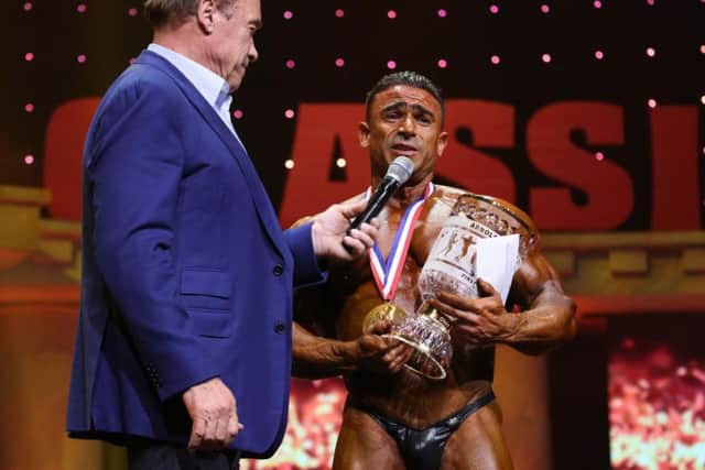 Kamal accepted the trophy and award money from Arnold Schwarzenegger on stage in Columbus, Ohio.