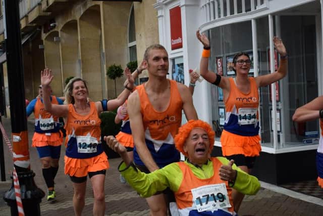 Even after his diagnosis of MND, Dave continued to cross finish lines, pushed in his wheelchair by his running club.