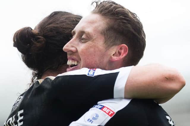 Joe Bunney celebrates with John-Joe O'Toole after the pair combined for the Cobblers' goal at Blackburn Rovers