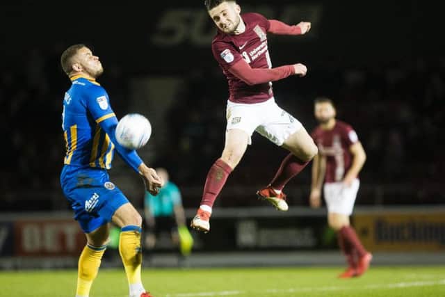 Matt Grimes wins a header during the Cobblers' 1-1 draw with Shrewsbury Town