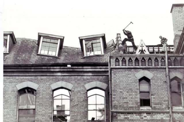 Workmen begin to knock down the school in 1979.