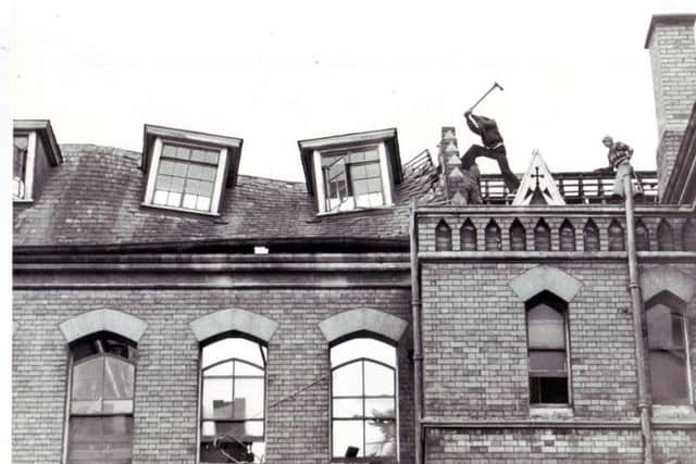 Workmen begin to knock down the school in 1979.