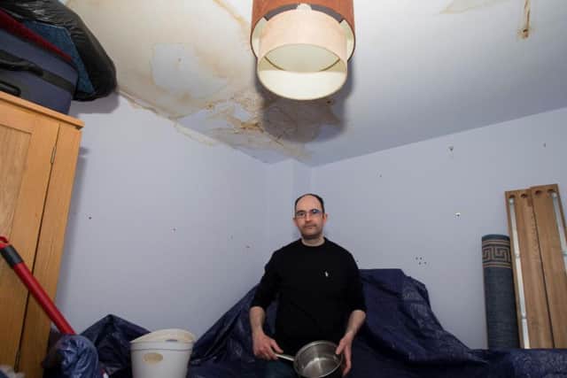 Daniel's bedroom ceiling has been completely stained and he has covered his belongings with tarpaulin to prevent them from further damage.
