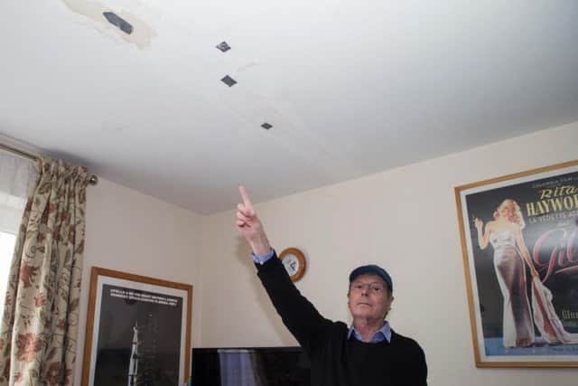 Charles Bole said the housing association painted over the holes.