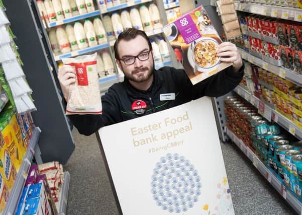 Co-op worker Shane Lewis was all smiles after customers and members in Northamptonshire helped collect more than 25,000 items as part of the Easter food bank appeal