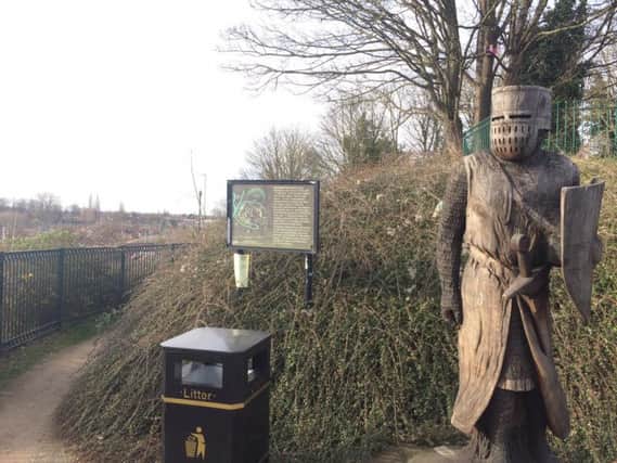 The existing footpath in Chalk Lane car park is marked by two wooden knights.