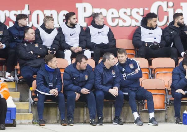 BAD NIGHT - the Cobblers' caretaker management team of (from left) Jon Brady, Jim Hollman, Andy Melville and Dean Austin watch their team stumble to defeat at Blackpool (Pictures: Kirsty Edmonds)
