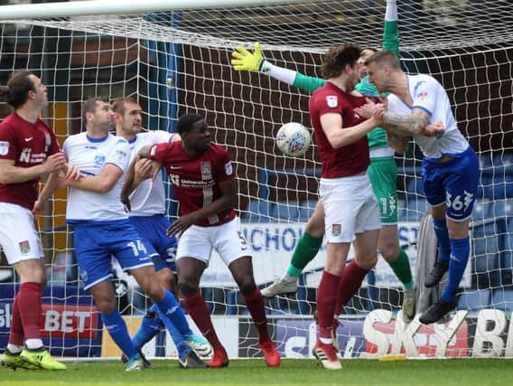 TELLING TOUCH: Ash Taylor glances Matt Grimes' corner into the bottom corner to hand the Cobblers a sixth-minute lead against Bury. Pictures: Sharon Lucey