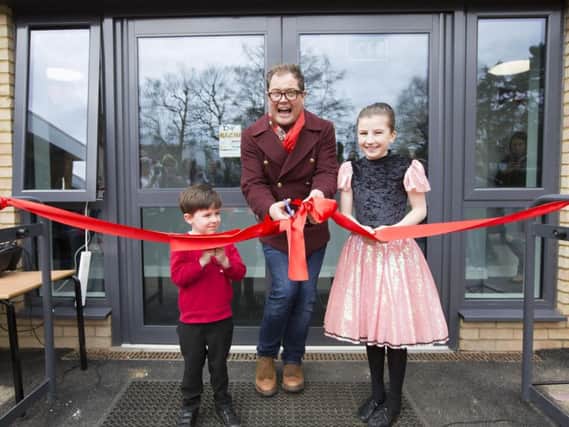 Alan Carr officially opened the school extension with pupils, Stanley Wallis (left) and Eve Dobson (right).