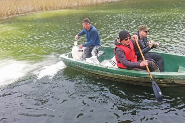 Towcesters Les Goodridge, Adam Walding and Steve Ward adding silt-busting lime to Astwell Mill
