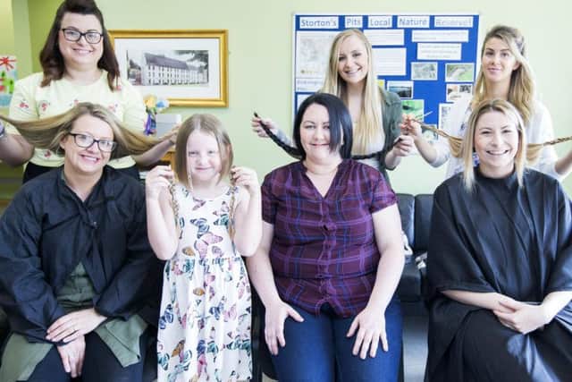 Four ladies had haircuts in aid of The Lewis Foundation at The Elgar Centre, Upton, Northampton. Front L-R: Zoe Clark, Ella Rose Neaves, Charlotte Buckley and Carlie Elliott. Back: L-R Samantha Winkel, Stacey Bailey and Michelle Silecchia.