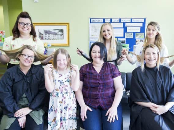 Four ladies had haircuts in aid of The Lewis Foundation at The Elgar Centre, Upton, Northampton. Front L-R: Zoe Clark, Ella Rose Neaves, Charlotte Buckley and Carlie Elliott. Back: L-R Samantha Winkel, Stacey Bailey and Michelle Silecchia.
