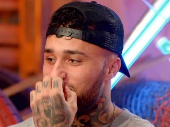 This screenshot taken from a teaser trailer for season three of MTV's Just Tattoo of Us shows Tian nervously chewing his nail as Natalie sees her new tattoo.