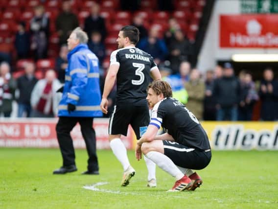 CRESTFALLEN: Ash Taylor and David Buchanan were left devastated at the full-time whistle. Pictures: Kirsty Edmonds