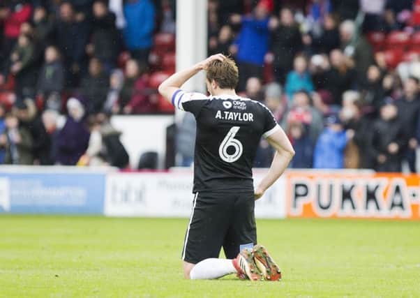 Ash Taylor is left on his knees following the Cobblers' defeatat Walsall on Saturday (Picture: Kirsty Edmonds)