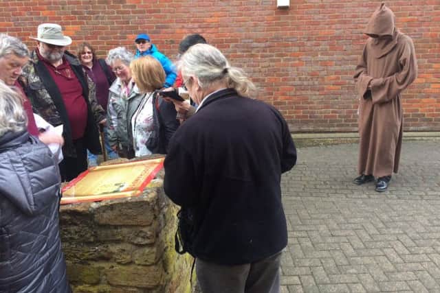 A Medieval monk watches as the new history plaques are unveiled.