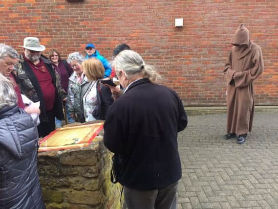 A Medieval monk watches as the new history plaques are unveiled.