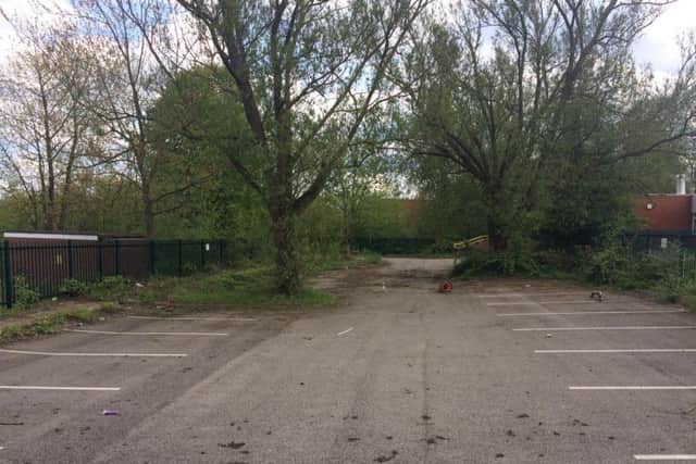 A car park with some 50 spaces behind the centre was closed in 2016 and sold to developers. It has been left untouched since.