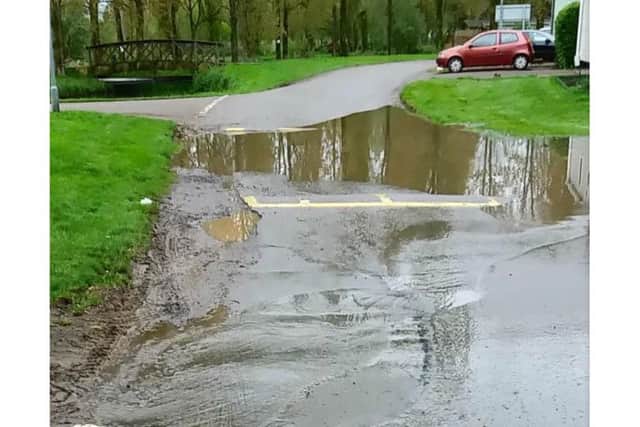 The wastewater can be seen bubbling up onto the road and forming large puddles.