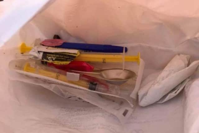 The bag was filled with drug paraphernalia including syringes and spoons.