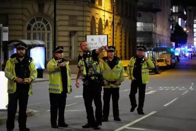 Police near the scene of the explosion in Manchester one year ago.