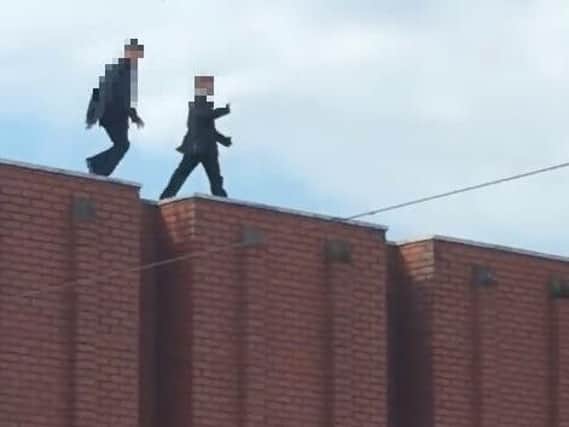 The shock video shows two young boys playing on the rooftops above Abington Street.