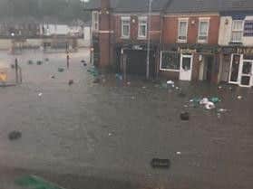 This street in Far Cotton has been left submerged with rubbish floating away down the road.