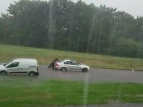 A man pushes his sunken car in Ringway, Far Cotton. Courtesy of Justyna Szyfelbajn.