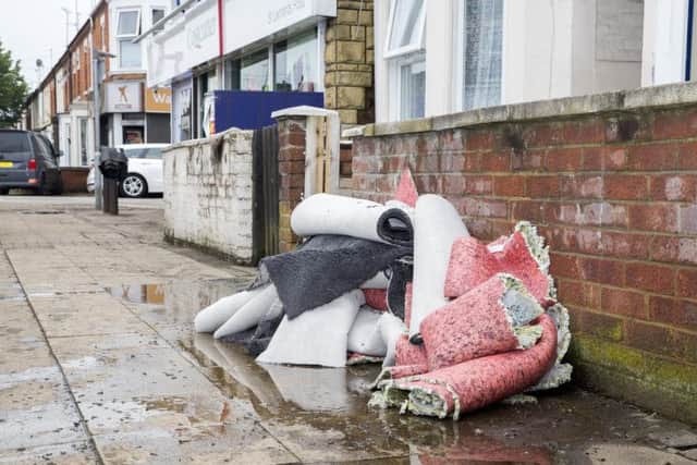 Sodden carpets had to be left out on the streets when the flood waters cleared.
