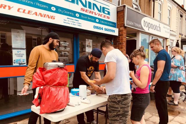 Four volunteers were working on the street while another four volunteers were preparing food.