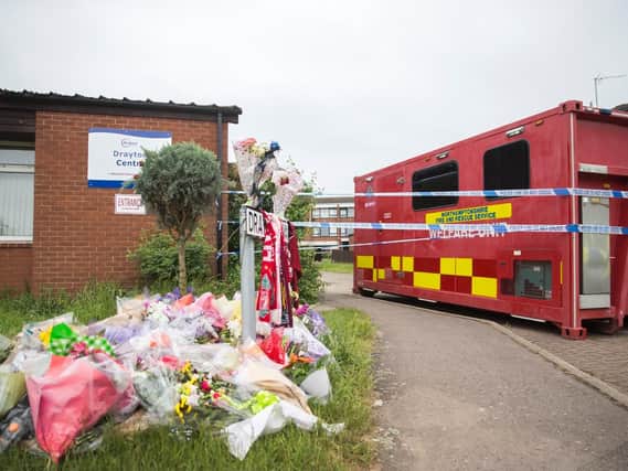 Flowers have been gathering at the scene of the murder in Drayton Walk this week.