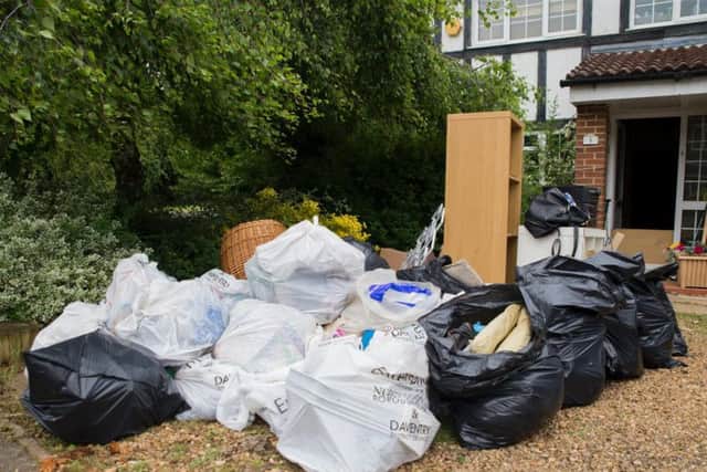 Bags of belongings have been stacked up on the Powell's driveway ready to be thrown out.