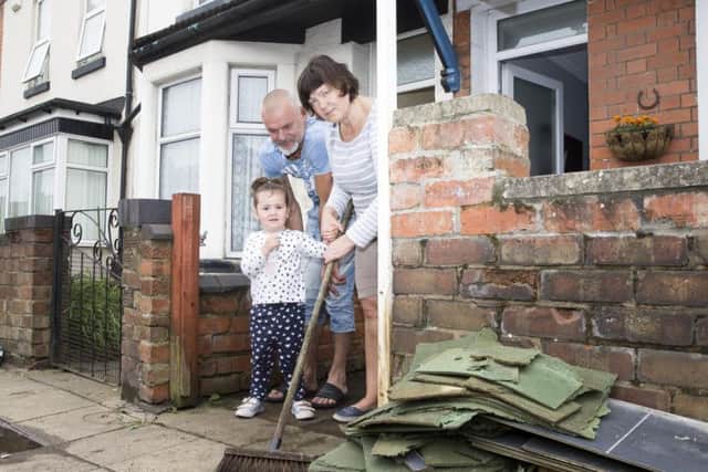 A family clears out their home in Far Cotton following the floods. Last night, victims clashed with the council over the authority's response.