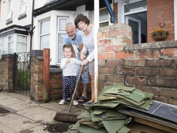 A family clears out their home in Far Cotton following the floods. Last night, victims clashed with the council over the authority's response.