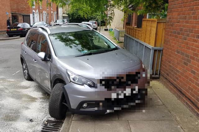 This car appears to have been shunted off the road and onto the pavement.