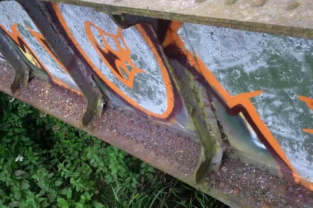 Graffiti on the disused bridge at Barnes Meadow (Pic via @OP_ILLUSTRATION)