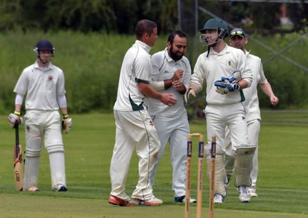 Bold Dragoon celebrate claiming a wicket in their clash with S&L Corby (Pictures: Dave Ikin)