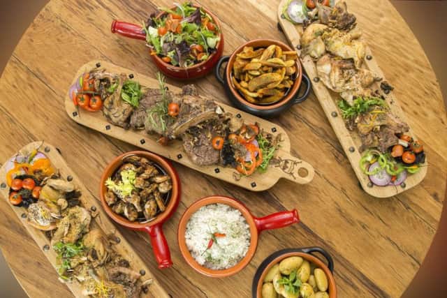 Two Cote De Boeuf rib steaks, two roasts chickens, four pork tomahawks and four duck legs, with a side of smoky chicken wings, boiled baby potatoes, paprika wings, rice and a chef's salad.