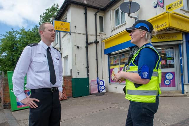 Chief Inspector James Willis pictured outside Fairfield News speaking with the local PCSO