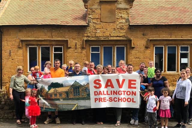 Parents and children pictured outside Dallington Pre-school which they are campaigning to keep open.