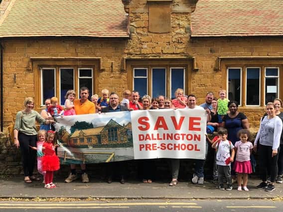 Parents and children pictured outside Dallington Pre-school which they are campaigning to keep open.