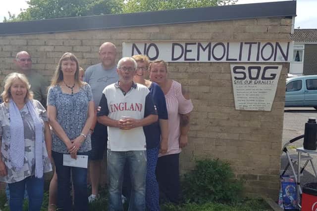 The group is calling on NPH to rethink building two new homes on their garages.