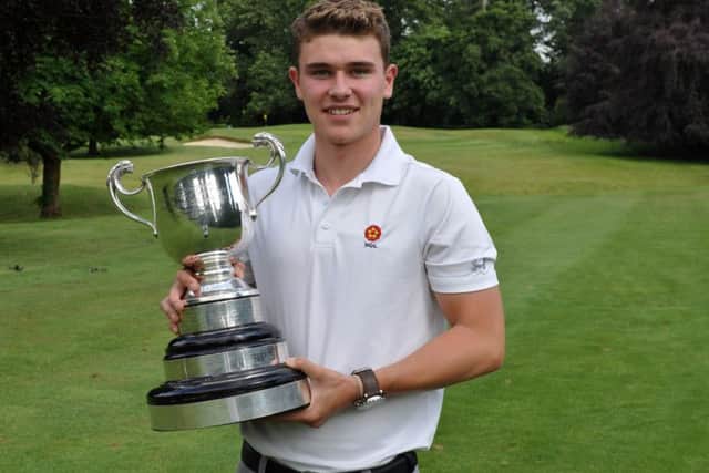 Liam McNeela pictured with the trophy after winning the County Mens Championship at Northampton GC