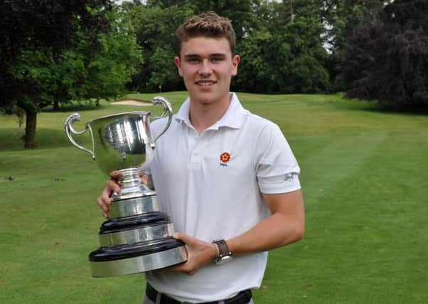 Liam McNeela pictured with the trophy after winning the County Mens Championship at Northampton GC
