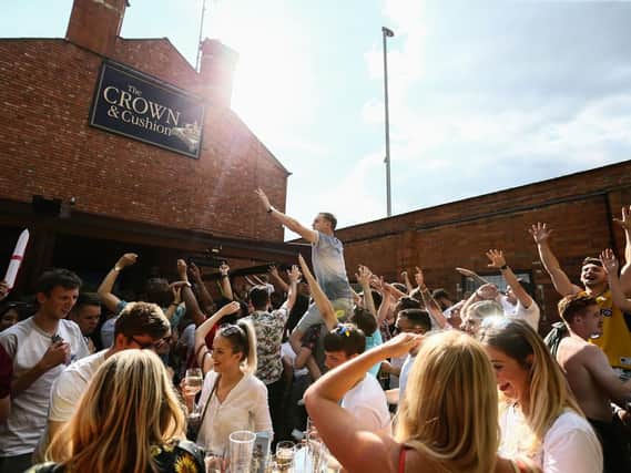 Fans at the Crown and Cushion celebrate after centre-back Harry Maguire pounces on a corner to give England the lead.